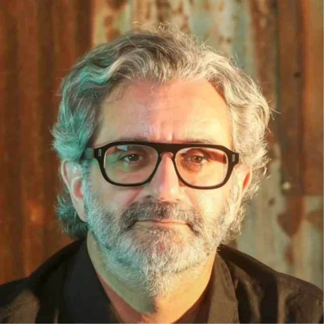 Portrait of Julian Cohen, advisor to BevGenie, with grey hair and beard and dark-framed glasses.