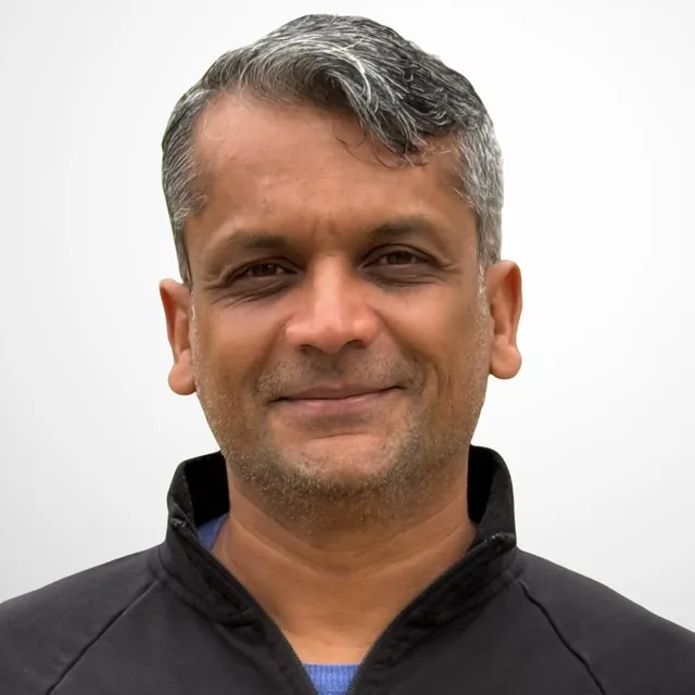 Portrait of Srinivas Jagannathan, Chief Product Officer at BevGenie, wearing a dark zip-up jacket.